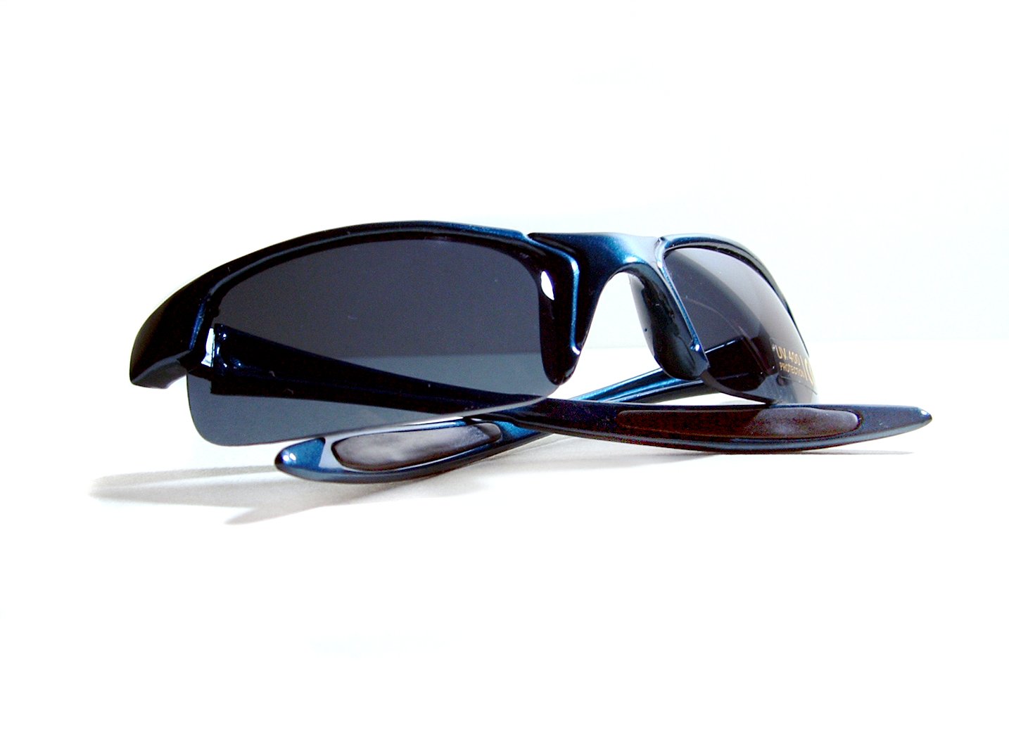 a pair of blue sunglasses and black frame sit on a white background