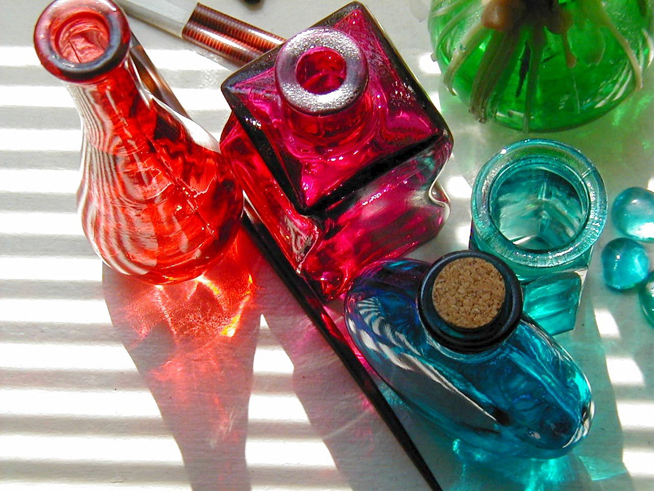 colorful bottles with lids and a nail polish bottle