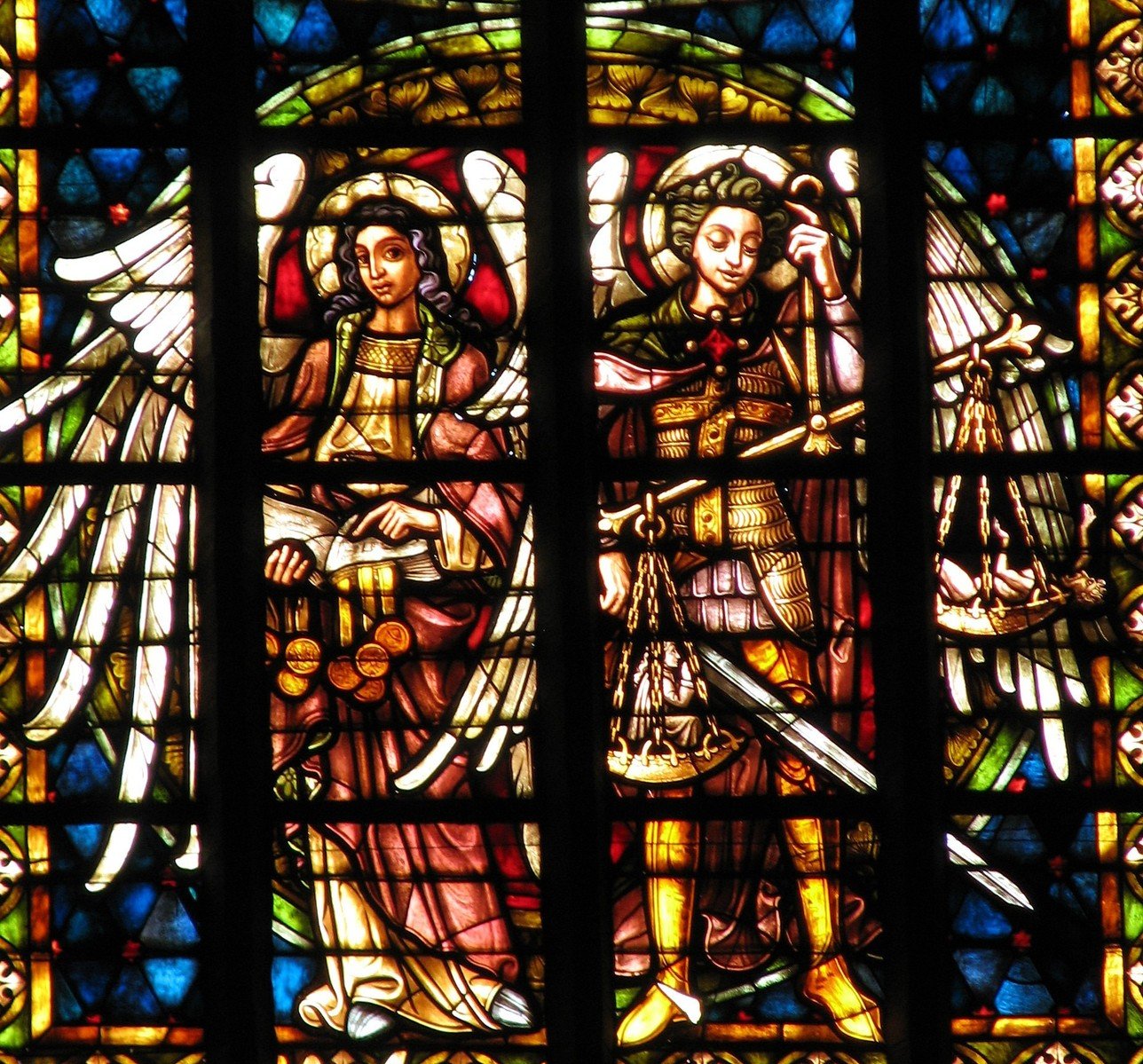 the stain glass window in a church features the angels holding weapons