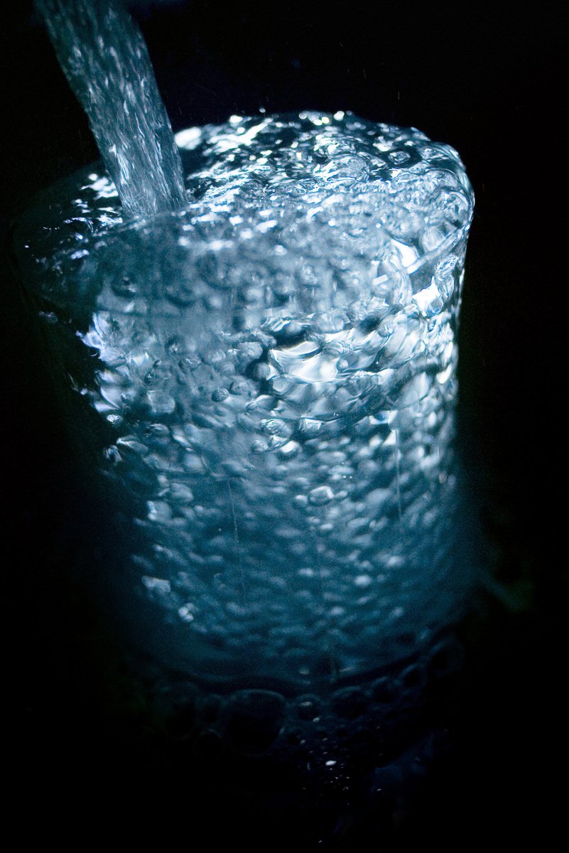 water gushing from a cup onto its surface