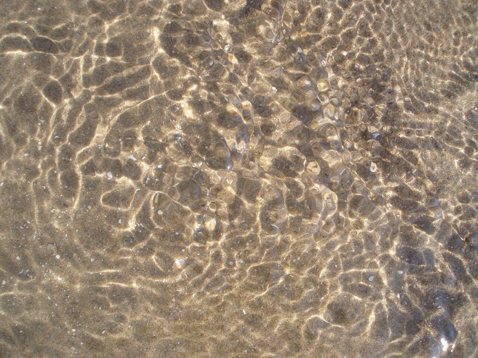 a sand and water design is shown in the ocean