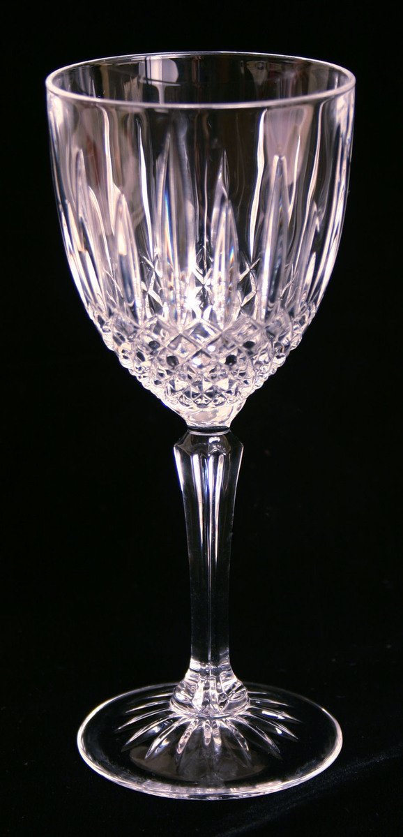 an old fashioned clear wine glass on black