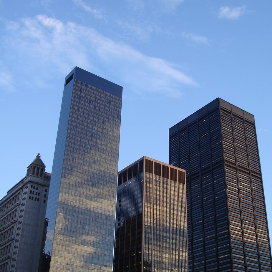 several skyscrs with a blue sky in the background