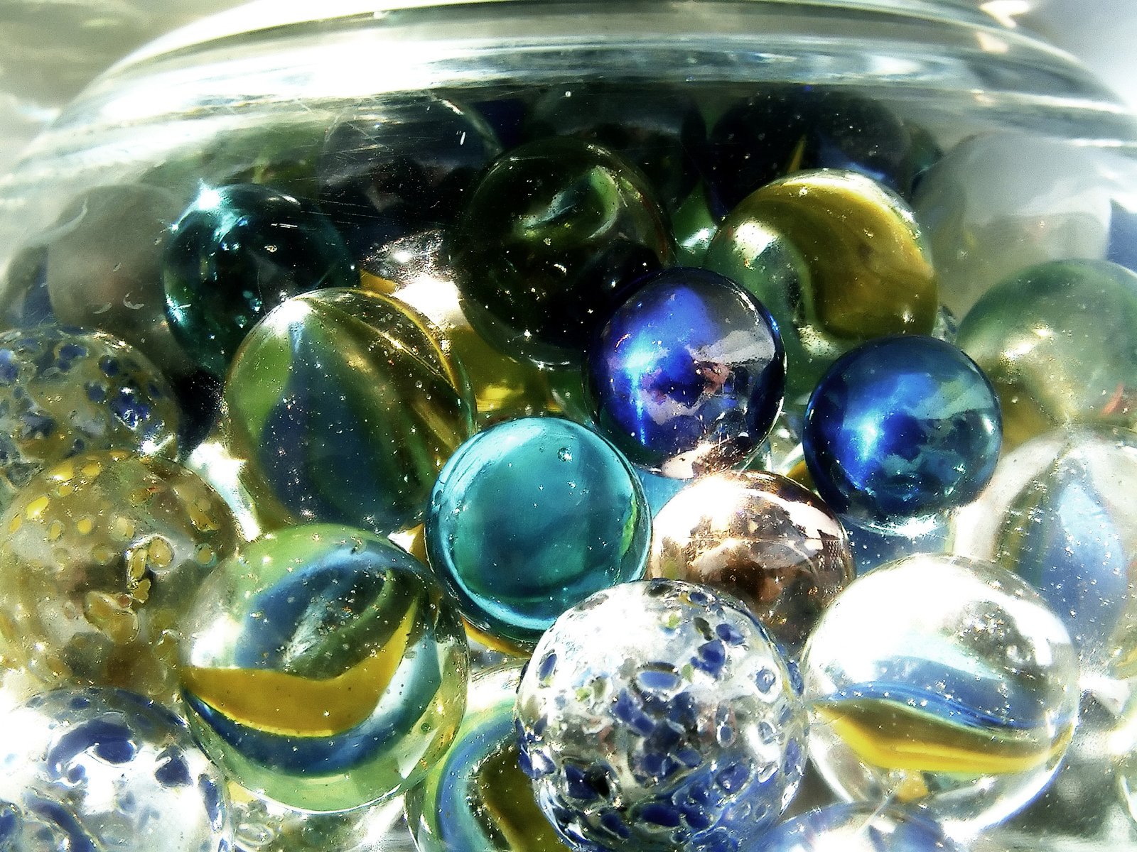 a glass container filled with glass balls on top of a table