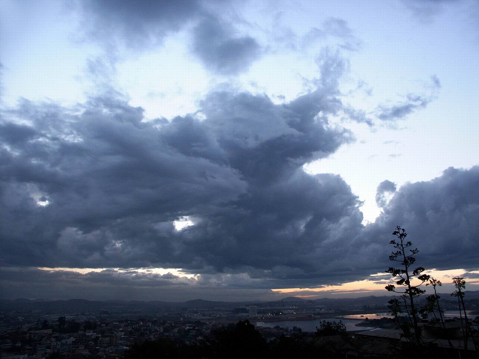 a picture taken looking over a field and towards the city below