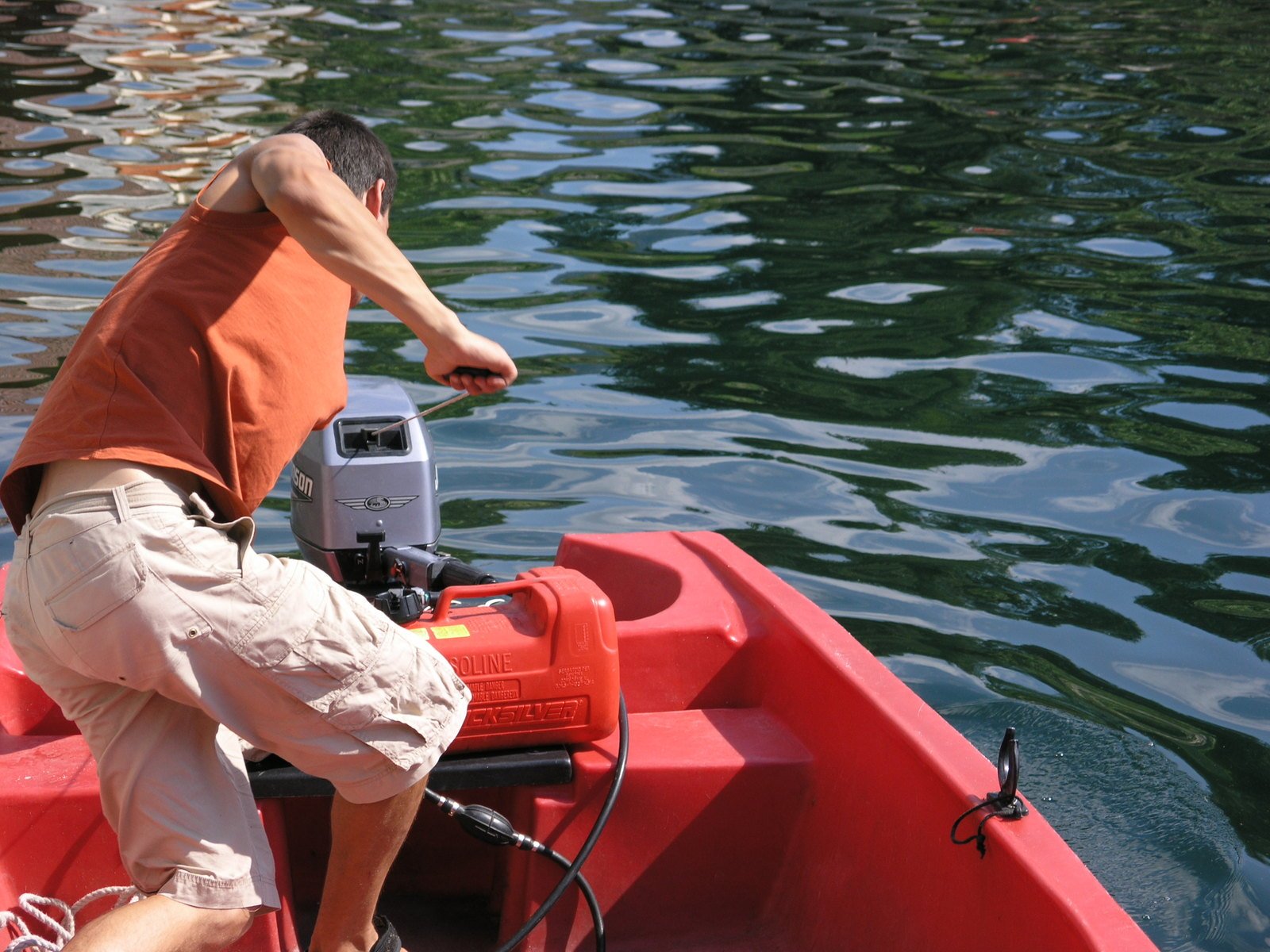 a man in an orange tank is using a machine to change the airflow rate of a boat