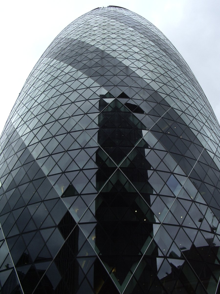 the glass building is a large triangle shaped structure