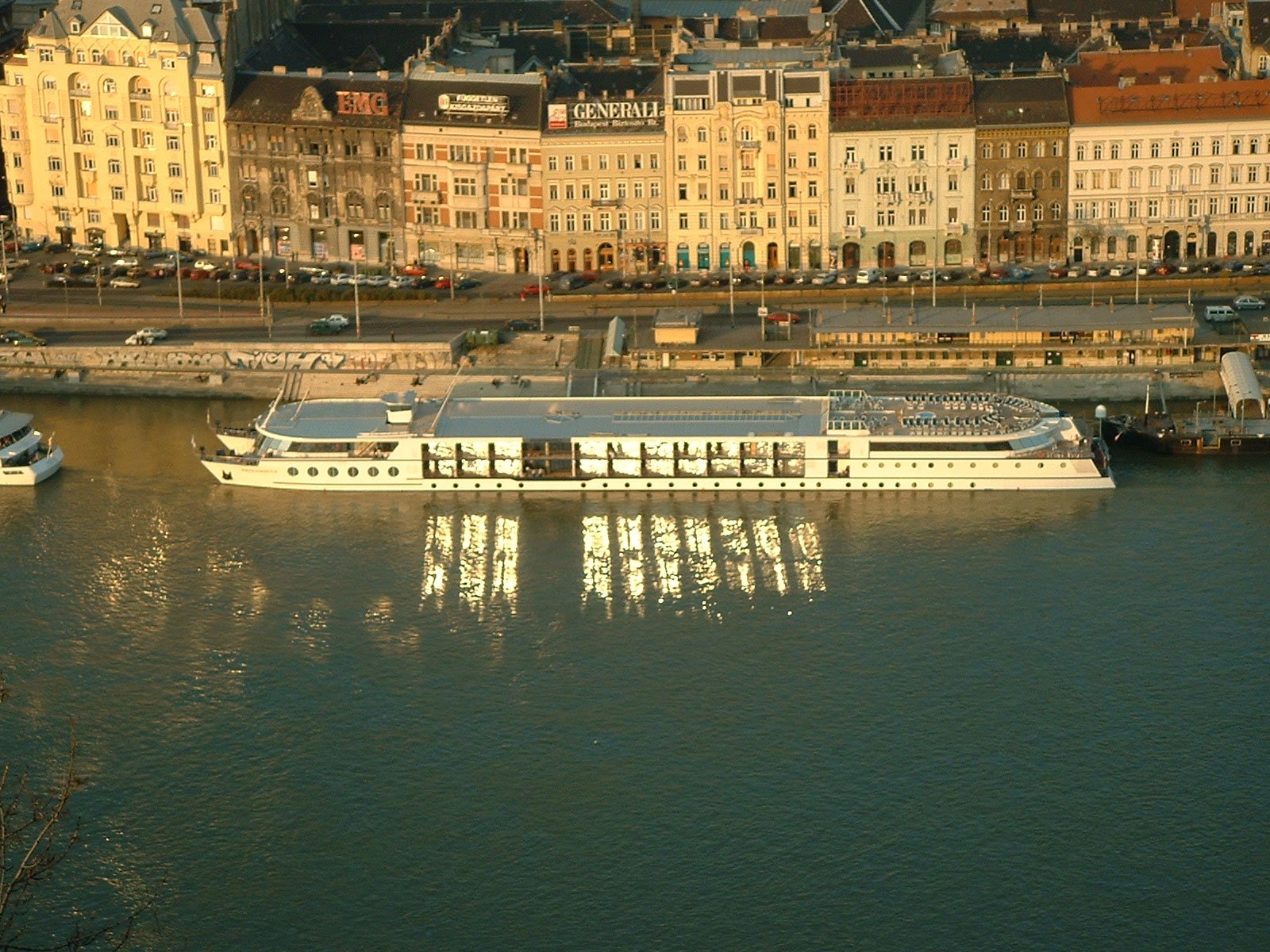 two passenger boats in the water next to a city