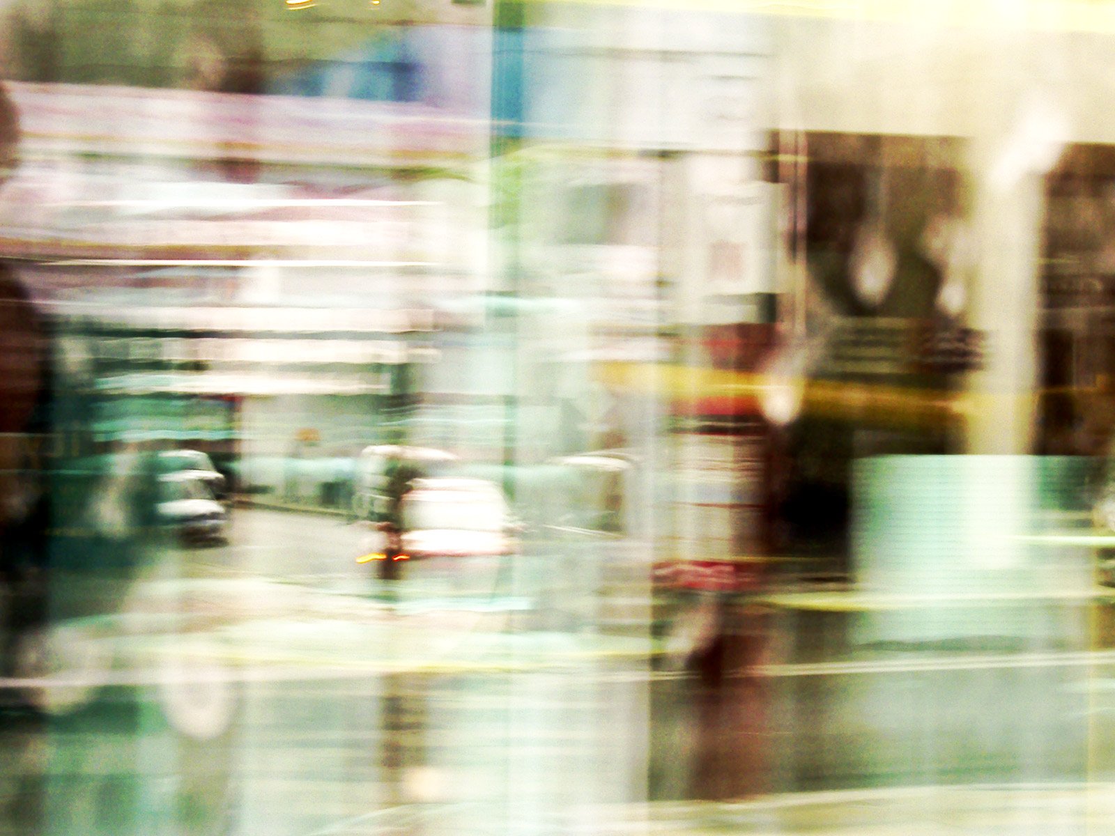 a blurry po of a city street, taken from inside a shop window