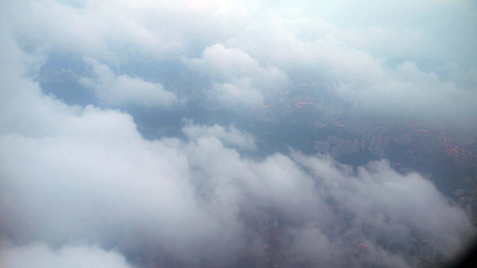 a view of the sky looking down at clouds