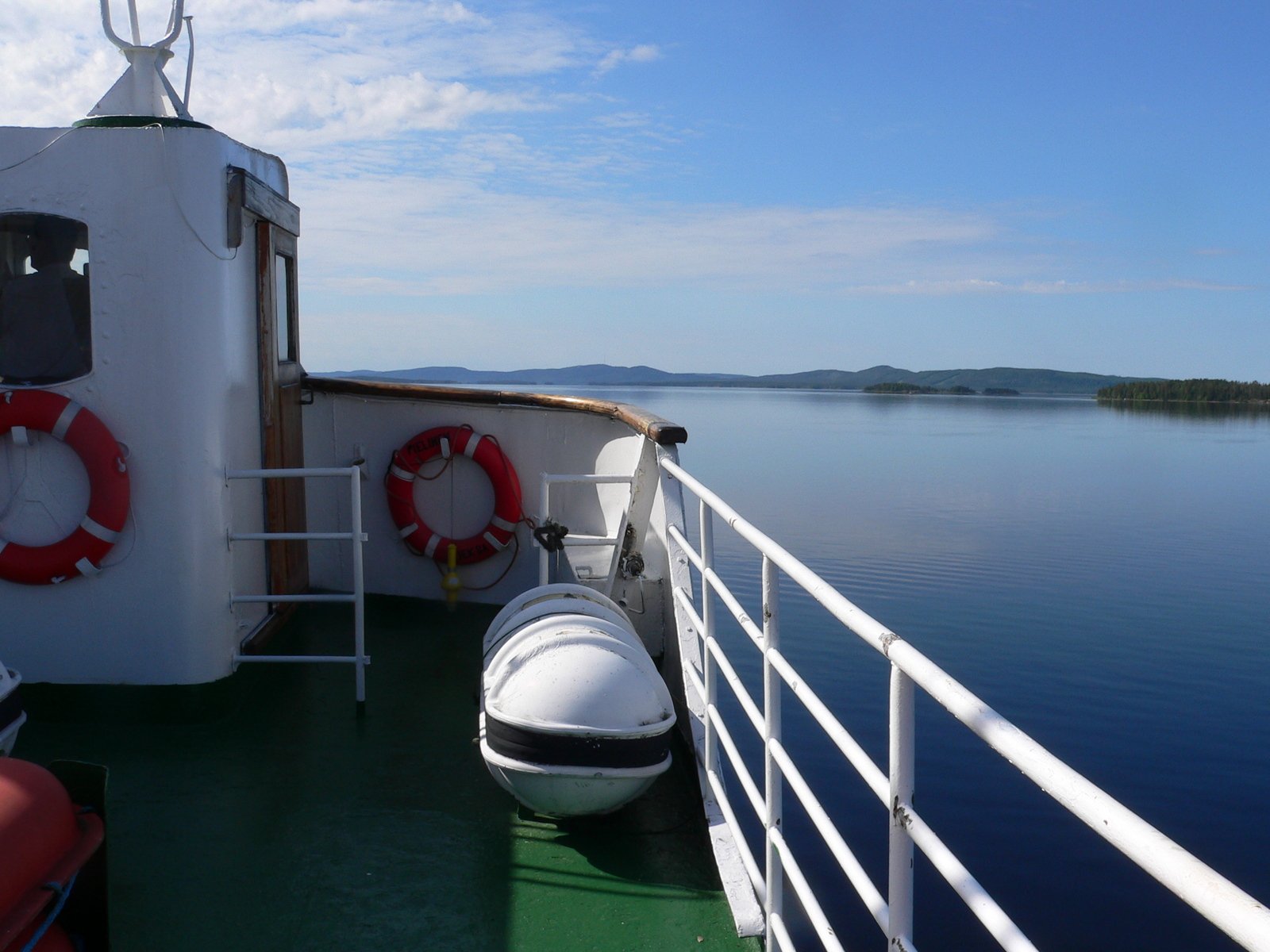 a boat is parked on the ferry with life preservers on the back