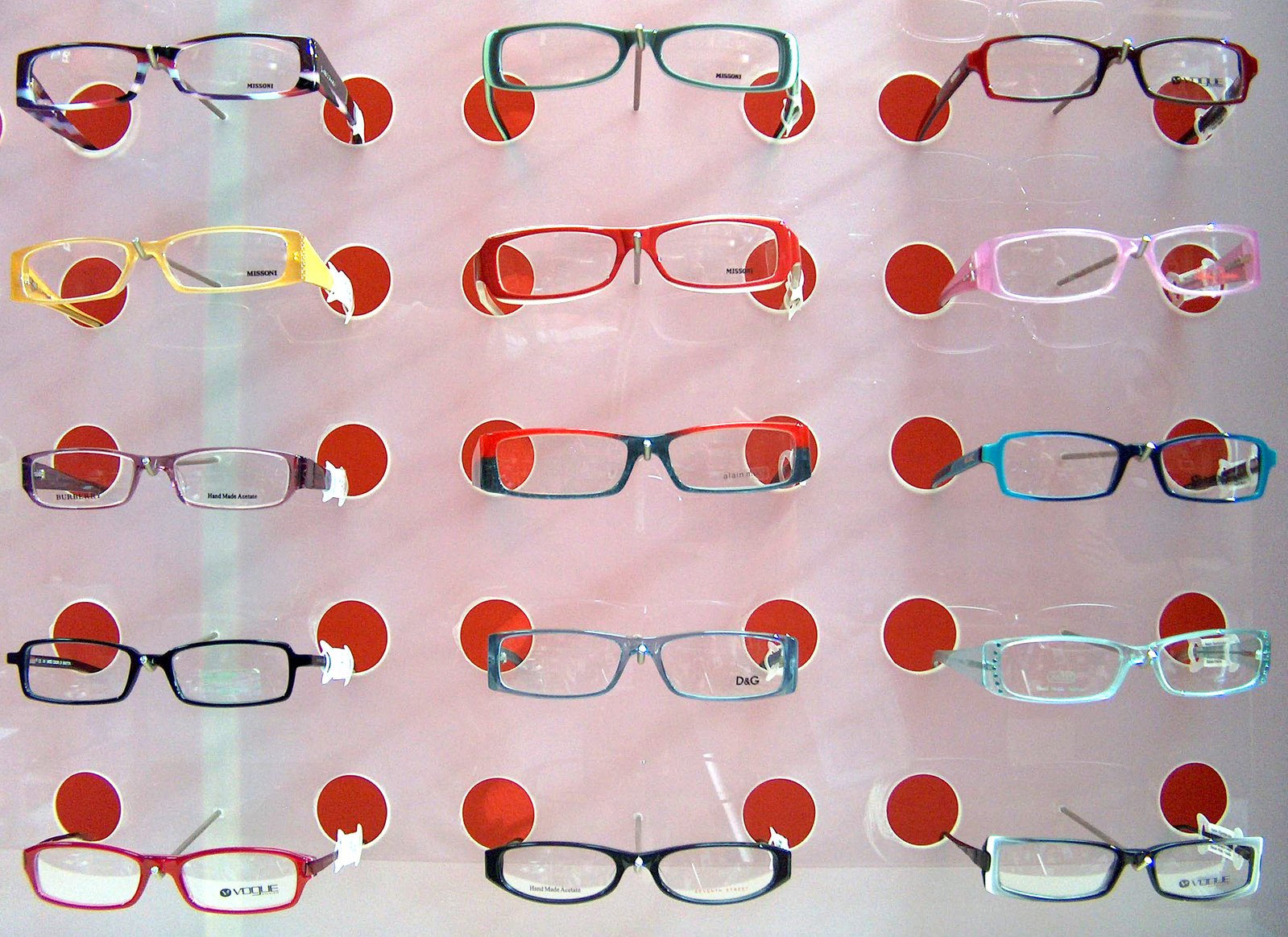 glasses are displayed on the window of a store