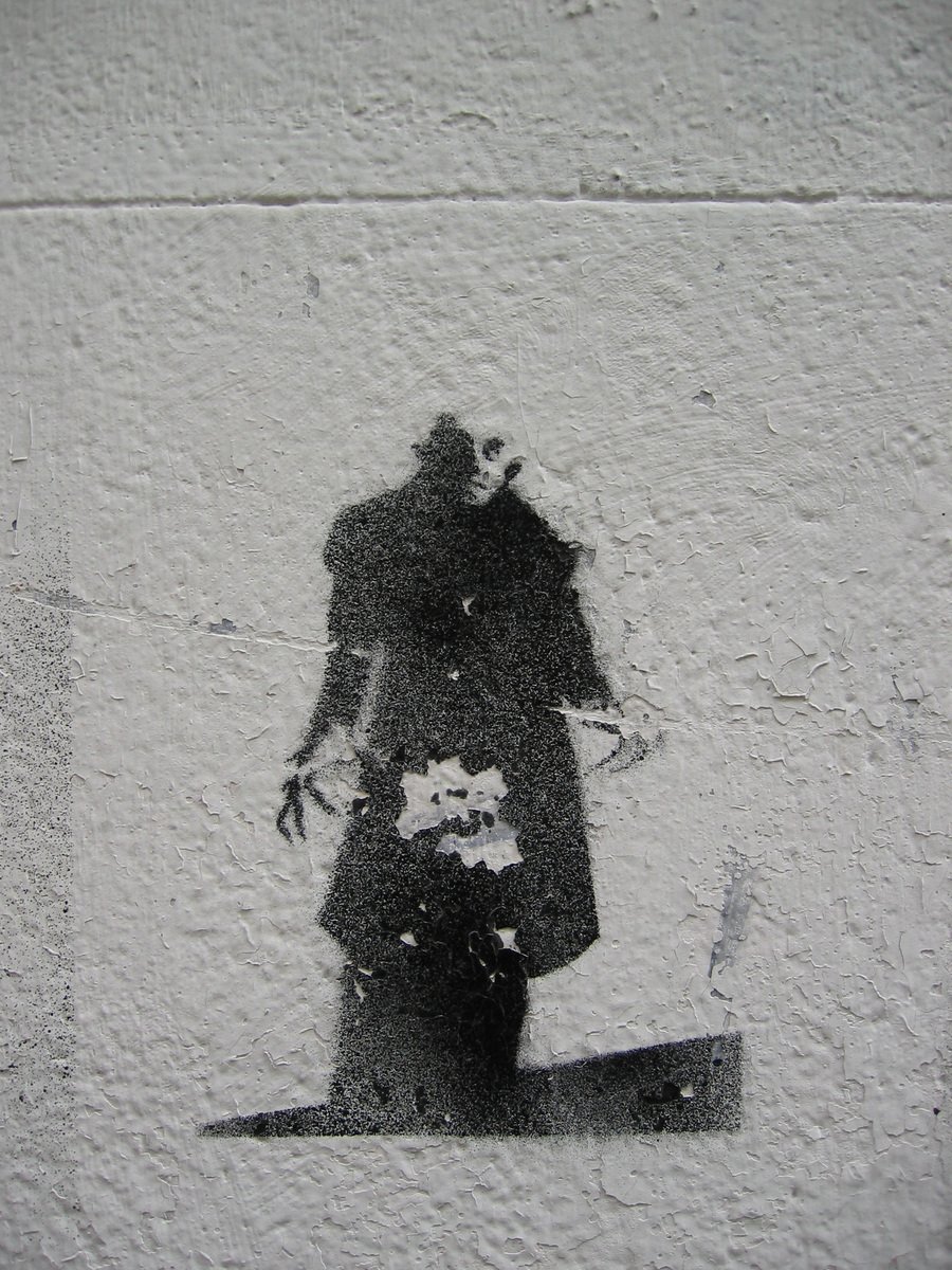 a white and black picture of a man on a wall