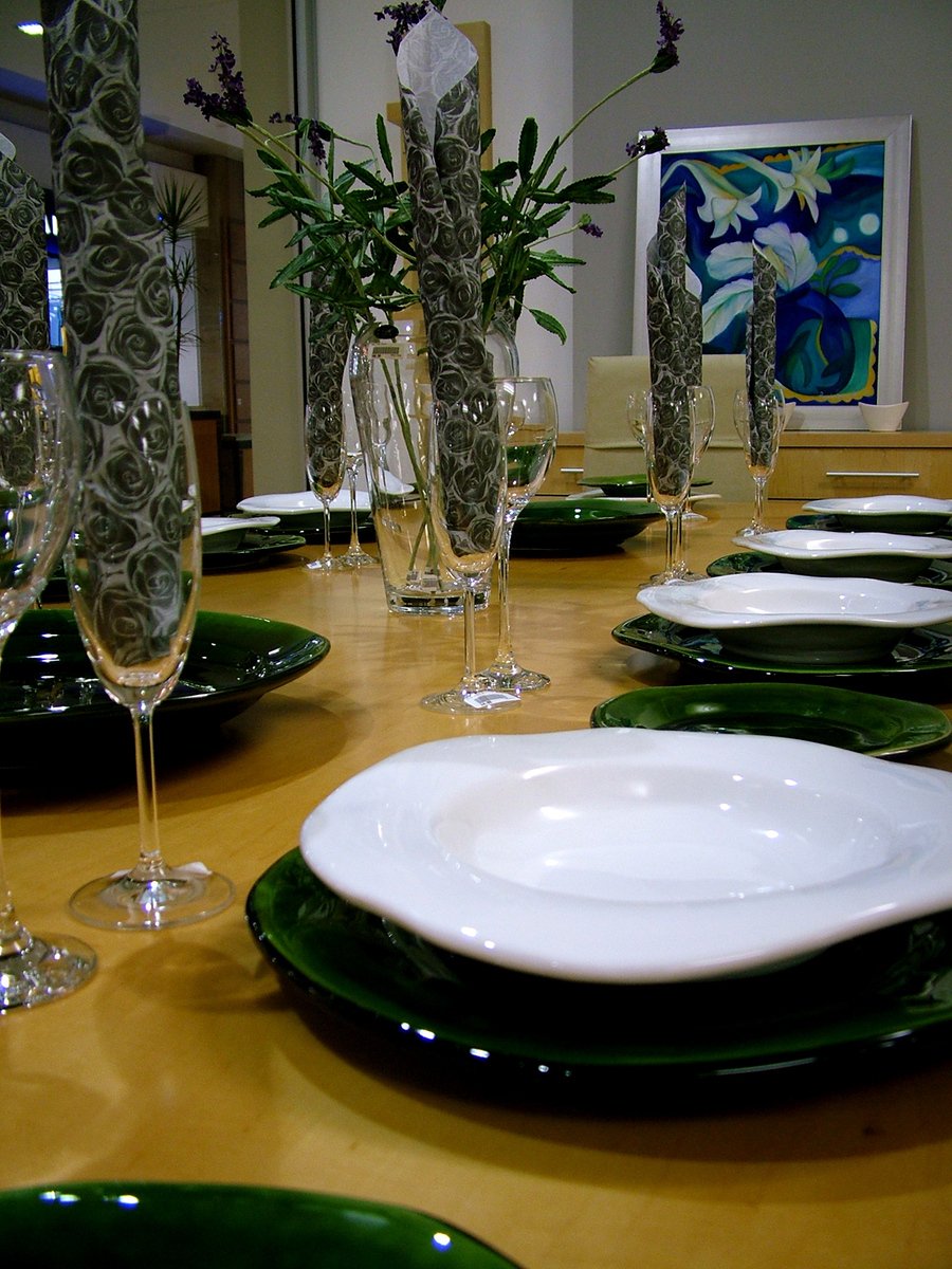 an empty white plate on a long table