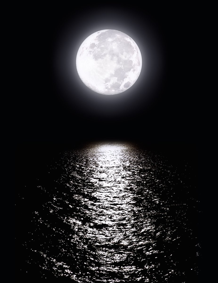 a large moon reflecting in the water at night