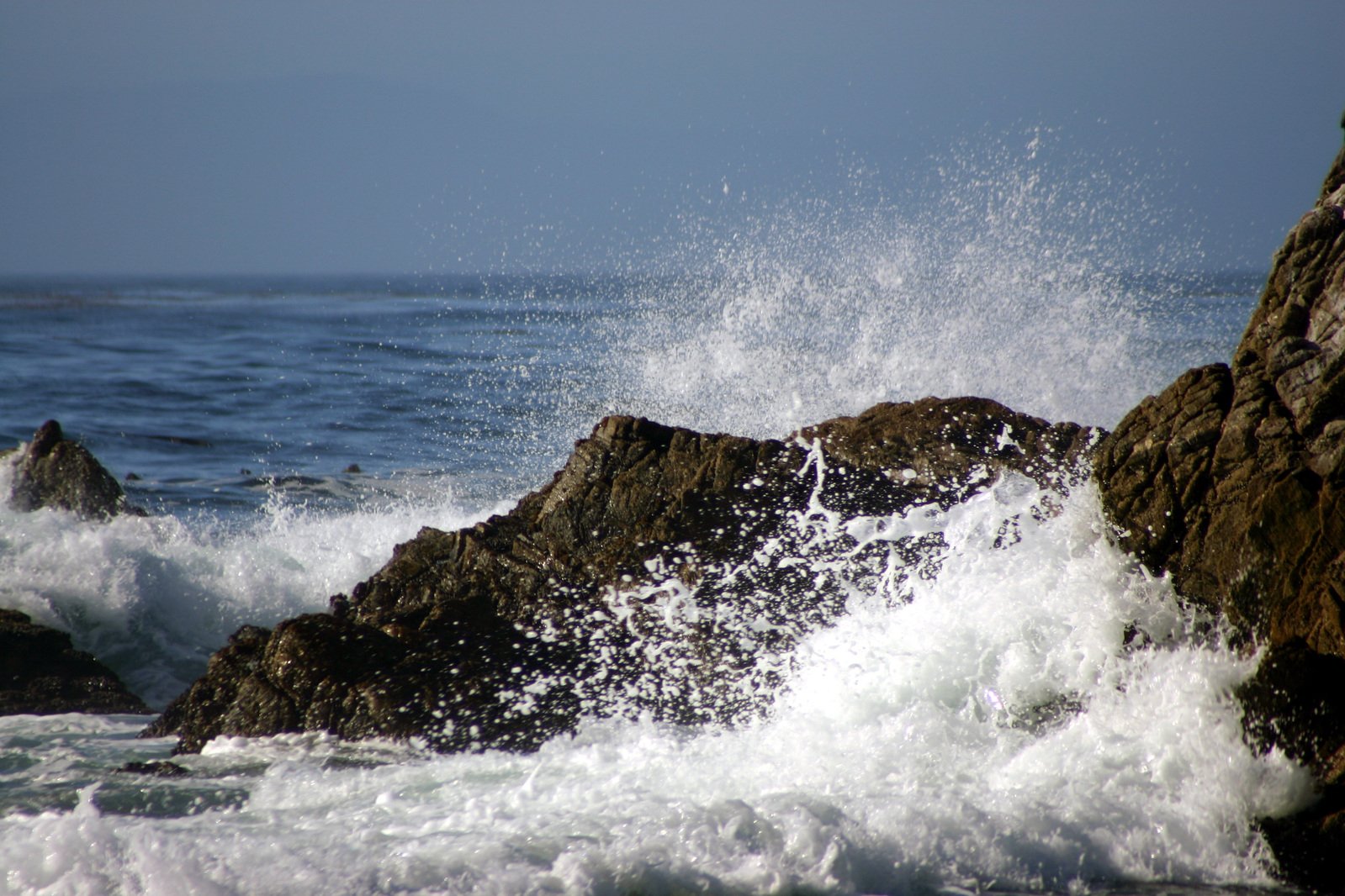 some ocean and rocks in the water