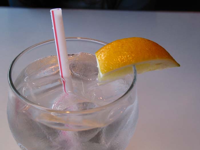 a drink with an orange on the side and a straw
