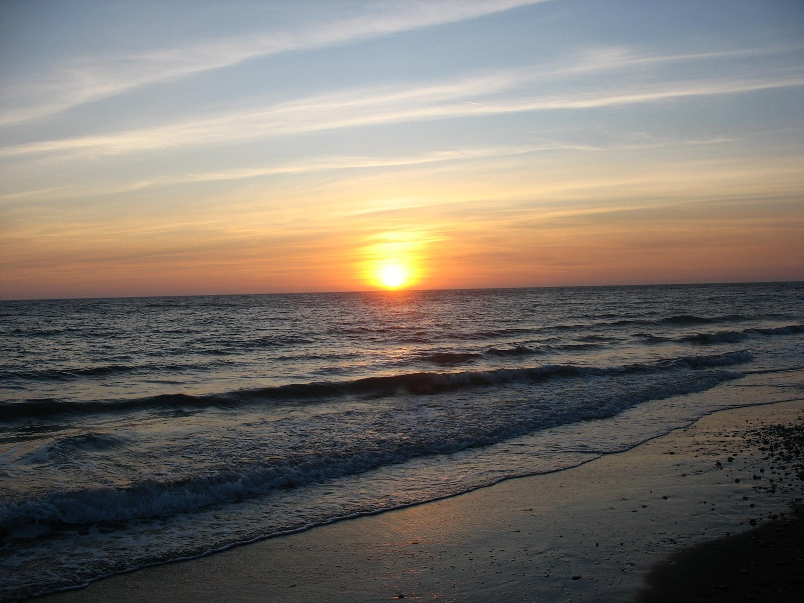 a body of water sitting next to a beach