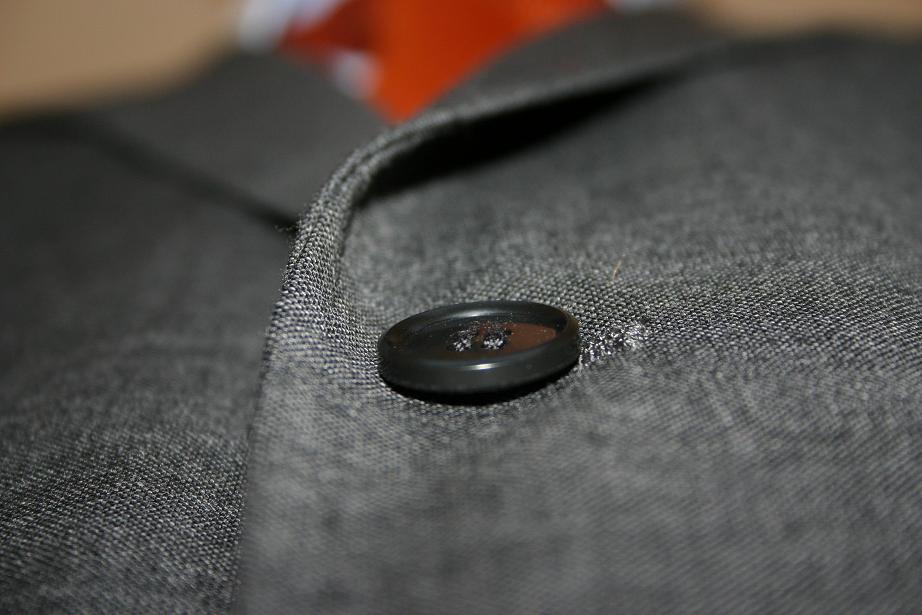 a small gray coat with a on attached