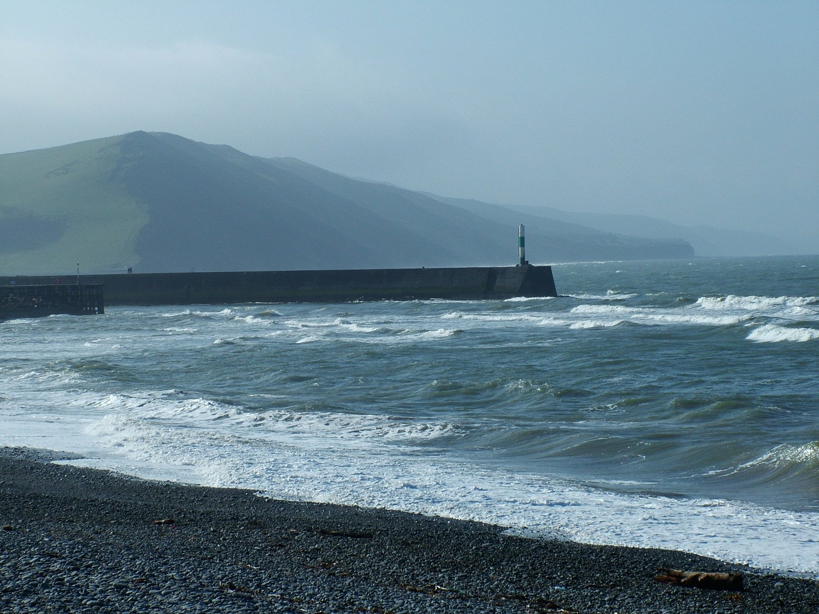 a couple of large waves crashing on to a shore