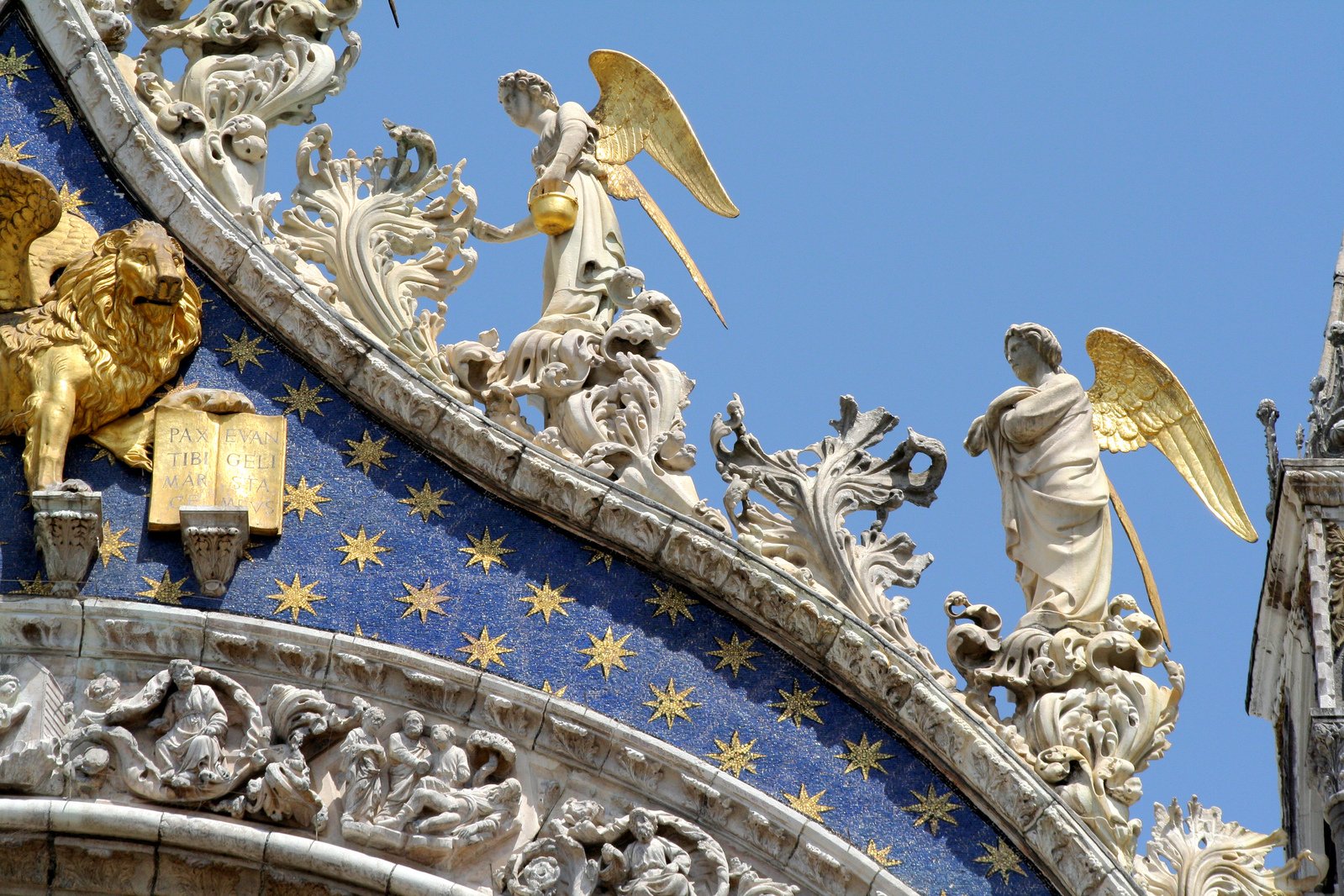 close up of ornate building with gold angels