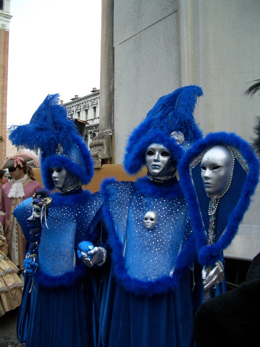 two blue - clad street performers in costume