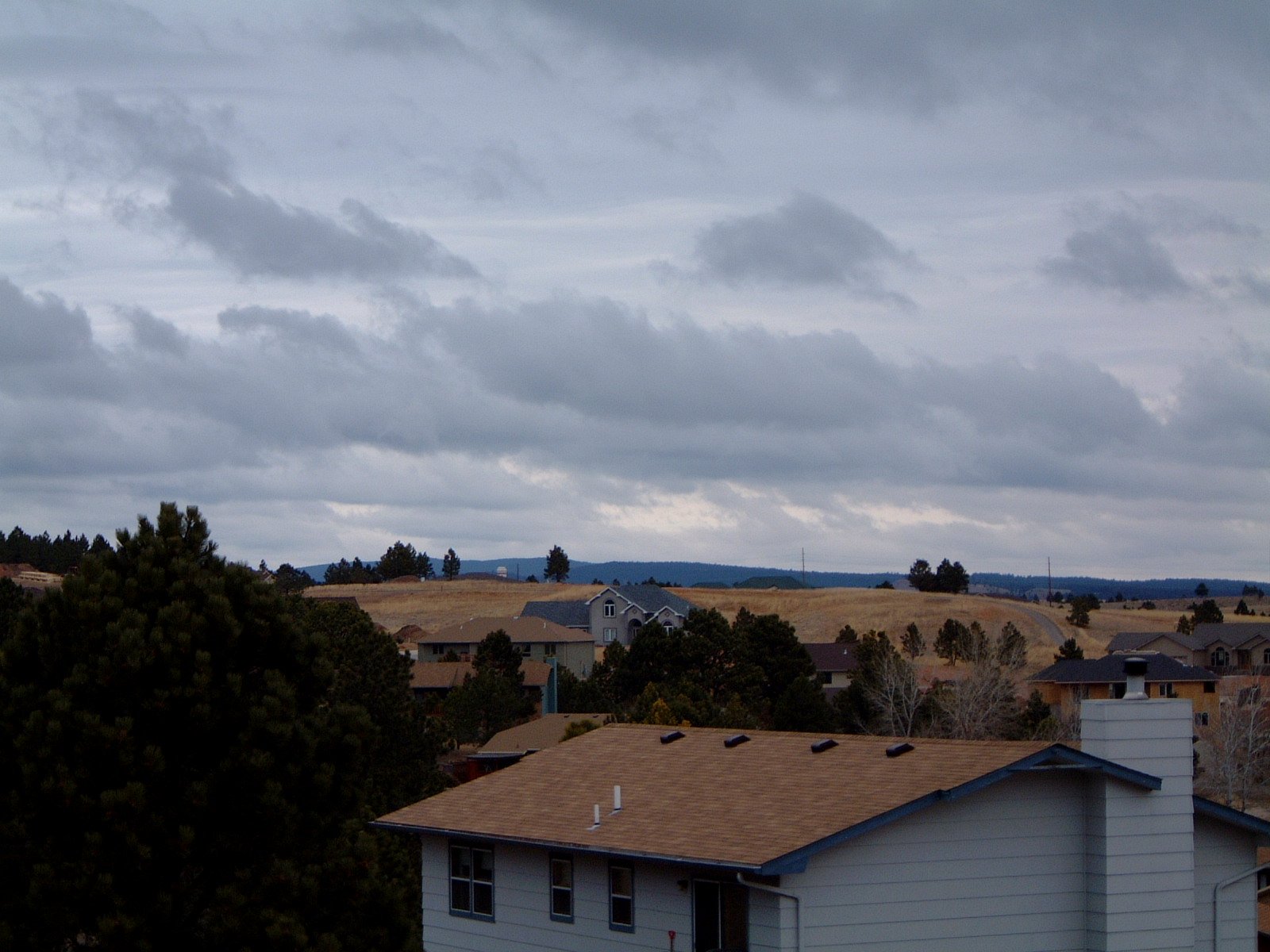 a group of houses on a cloudy day