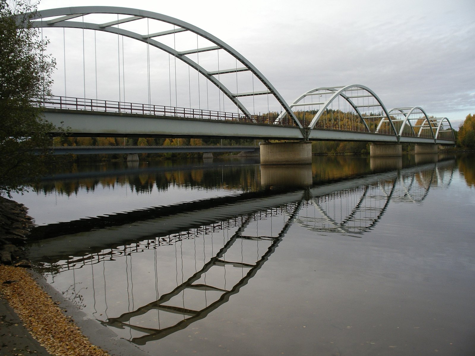 an old bridge over a wide body of water