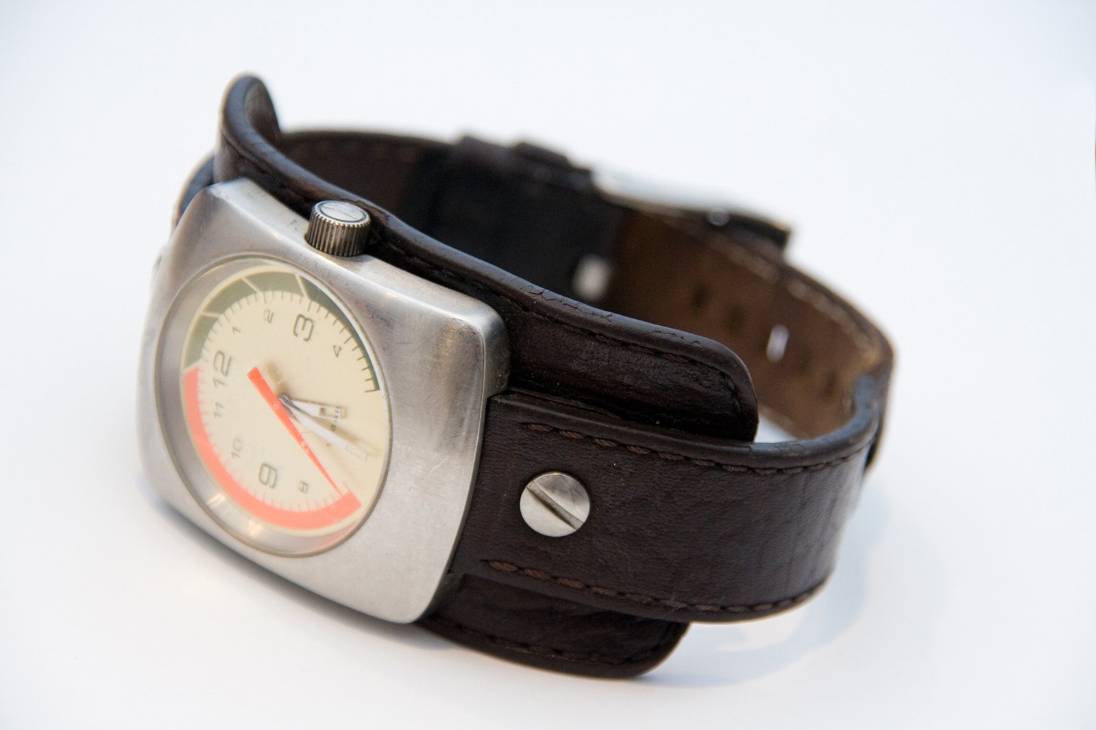 a brown strap around a watch with an orange second second hand time