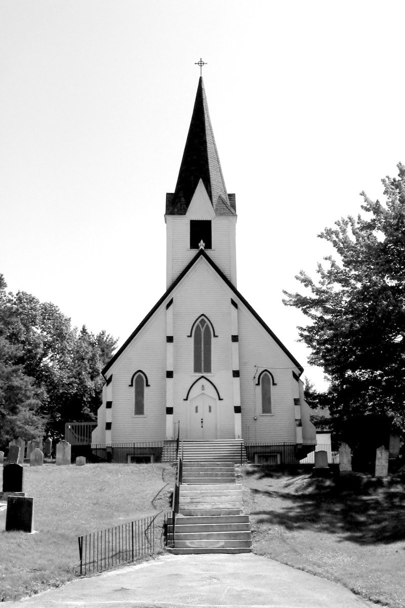 black and white pograph of church steeple on a sunny day