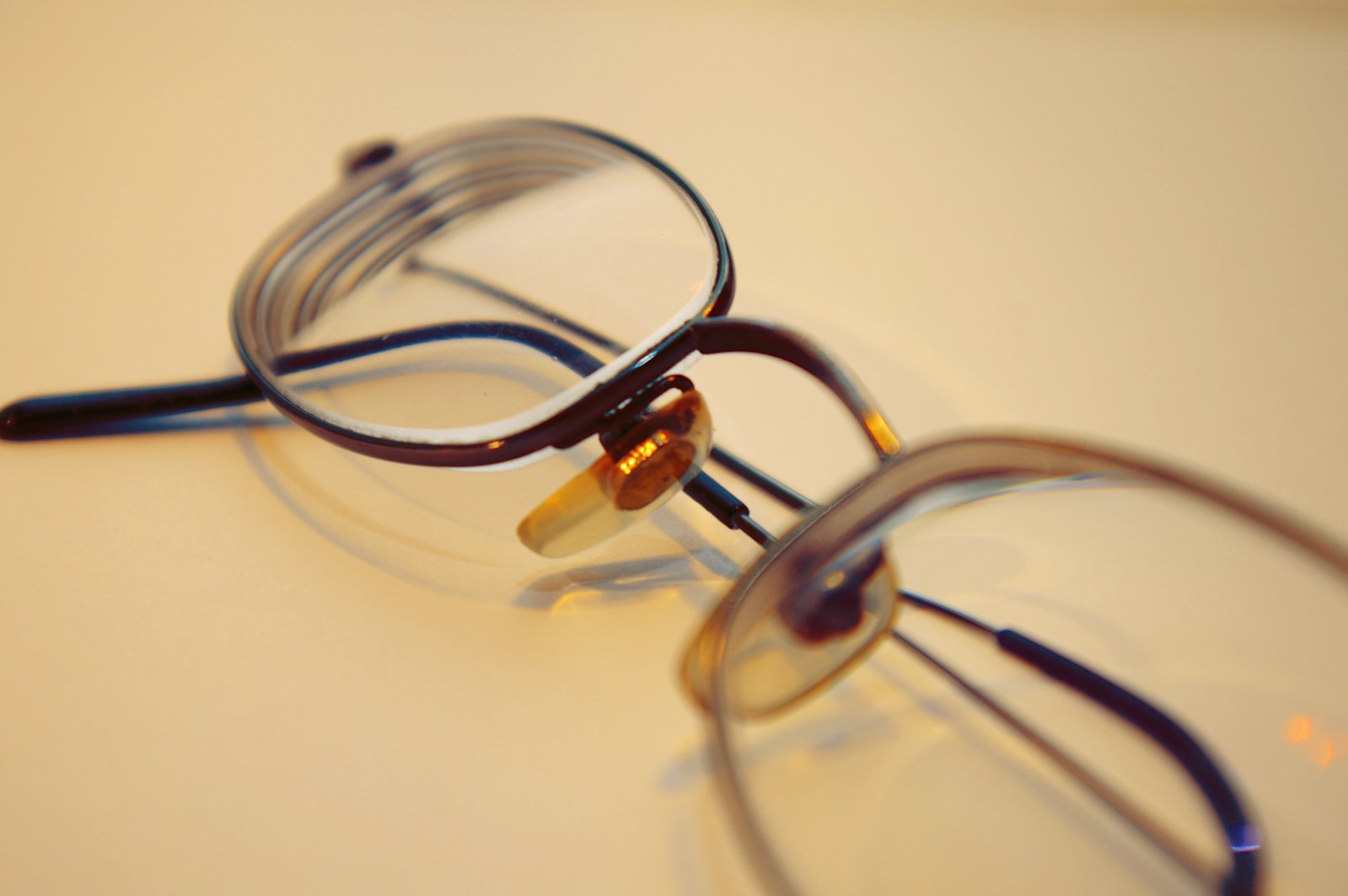 a pair of glasses with gold rims are sitting on a table