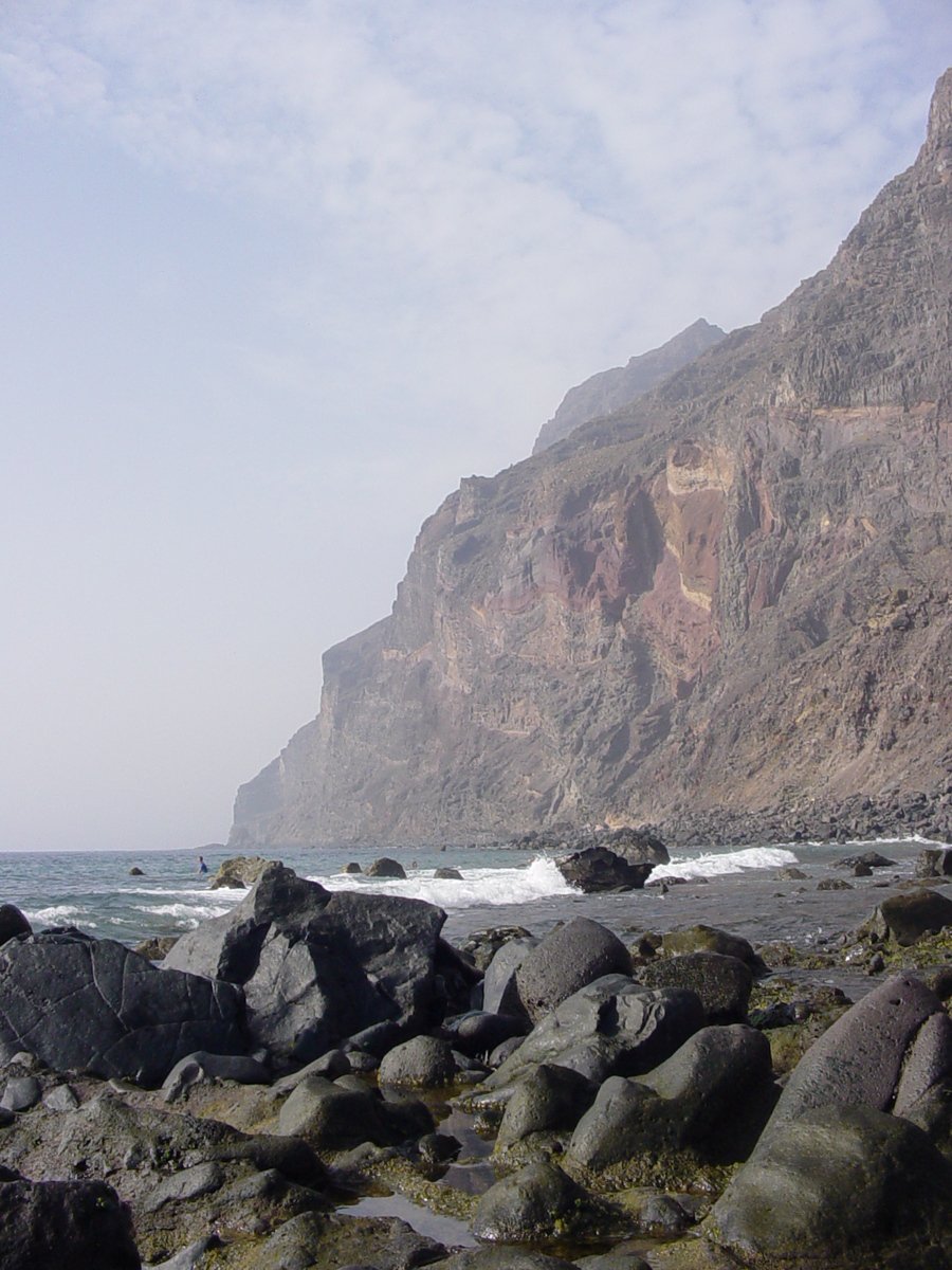 a very wide rock covered shoreline near the ocean