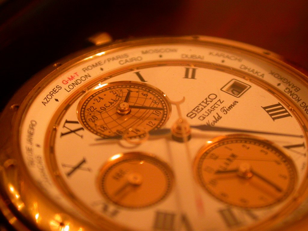 a very fancy gold watch with many interesting faces