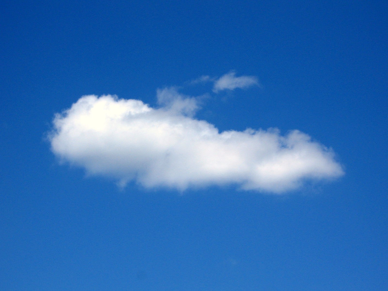 a large cloud is in the sky on a sunny day