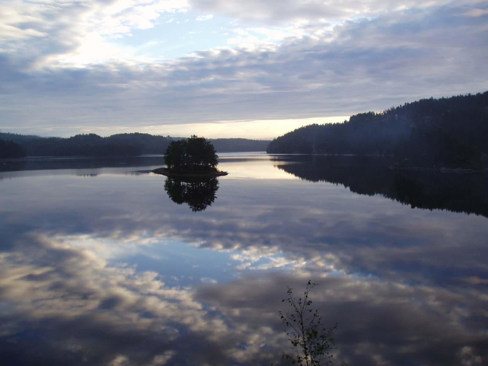 a boat is in a body of water with a reflection