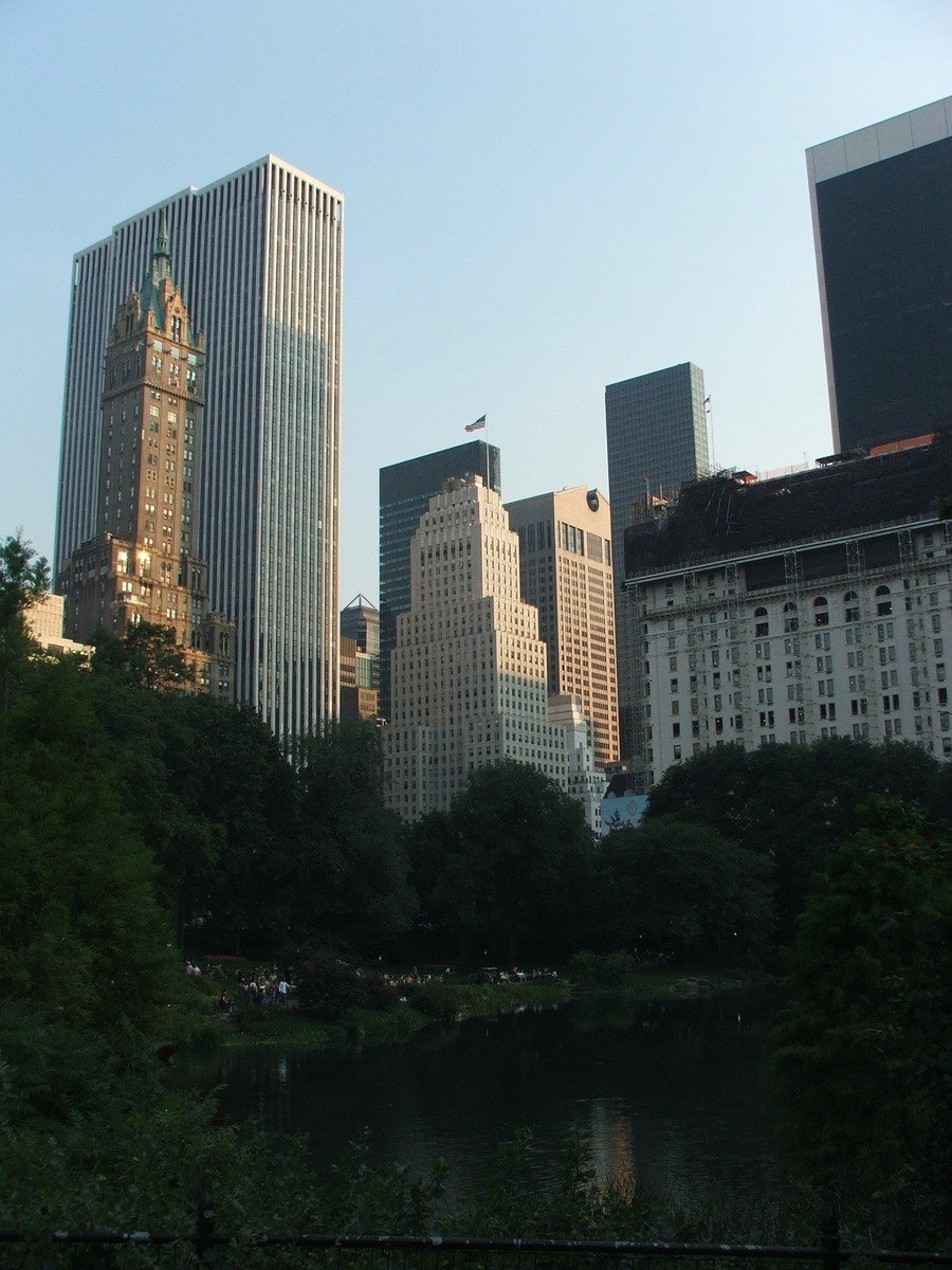 the city skyline with tall buildings next to a body of water