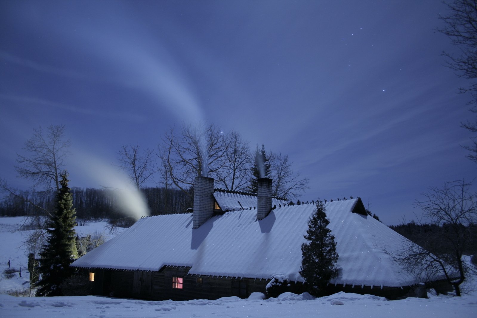 snow blows from a cloud above a house