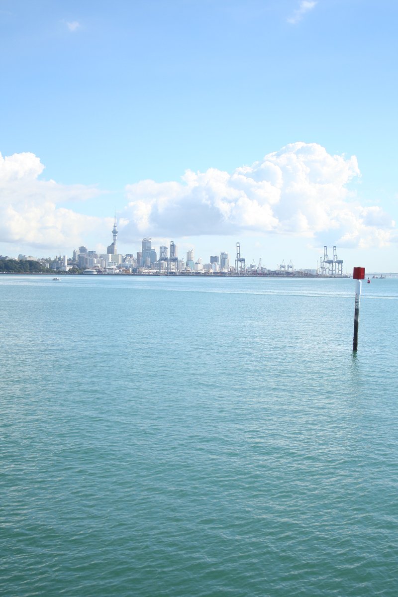 an ocean with a city skyline in the distance