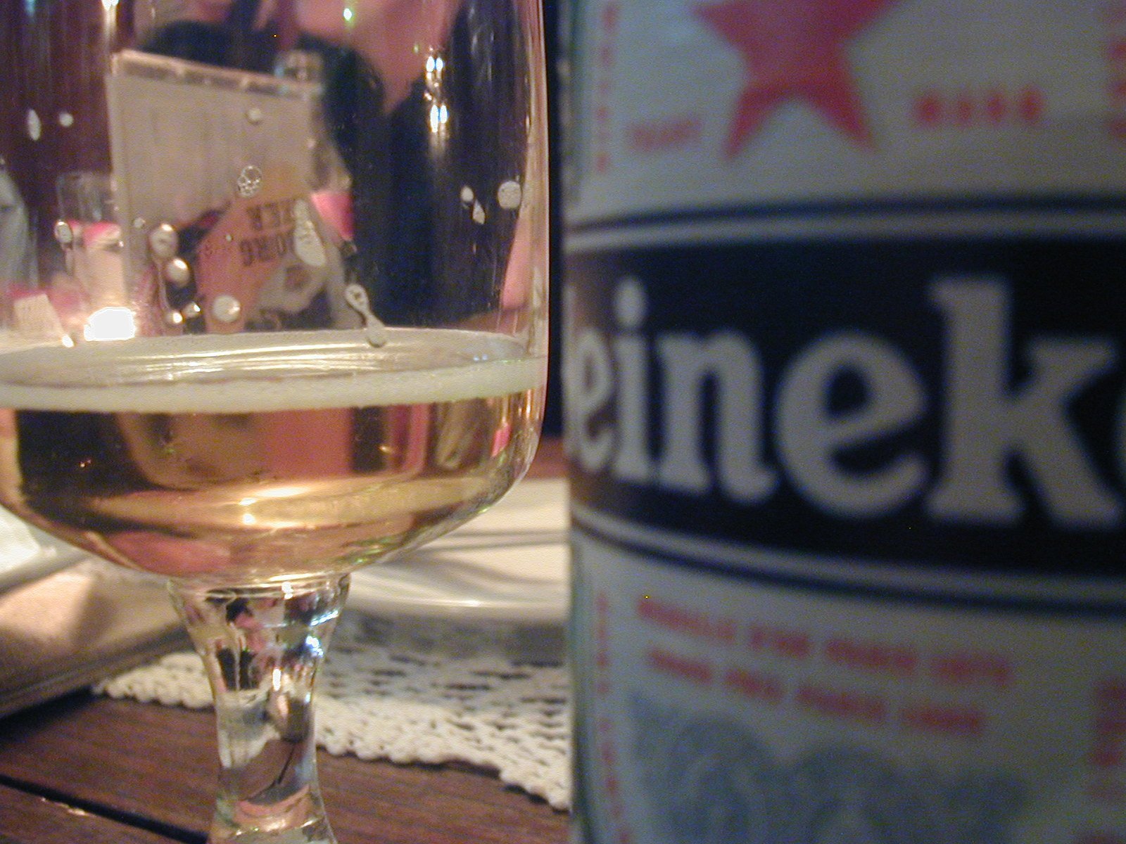 a glass of beer and the can of kronken on a table