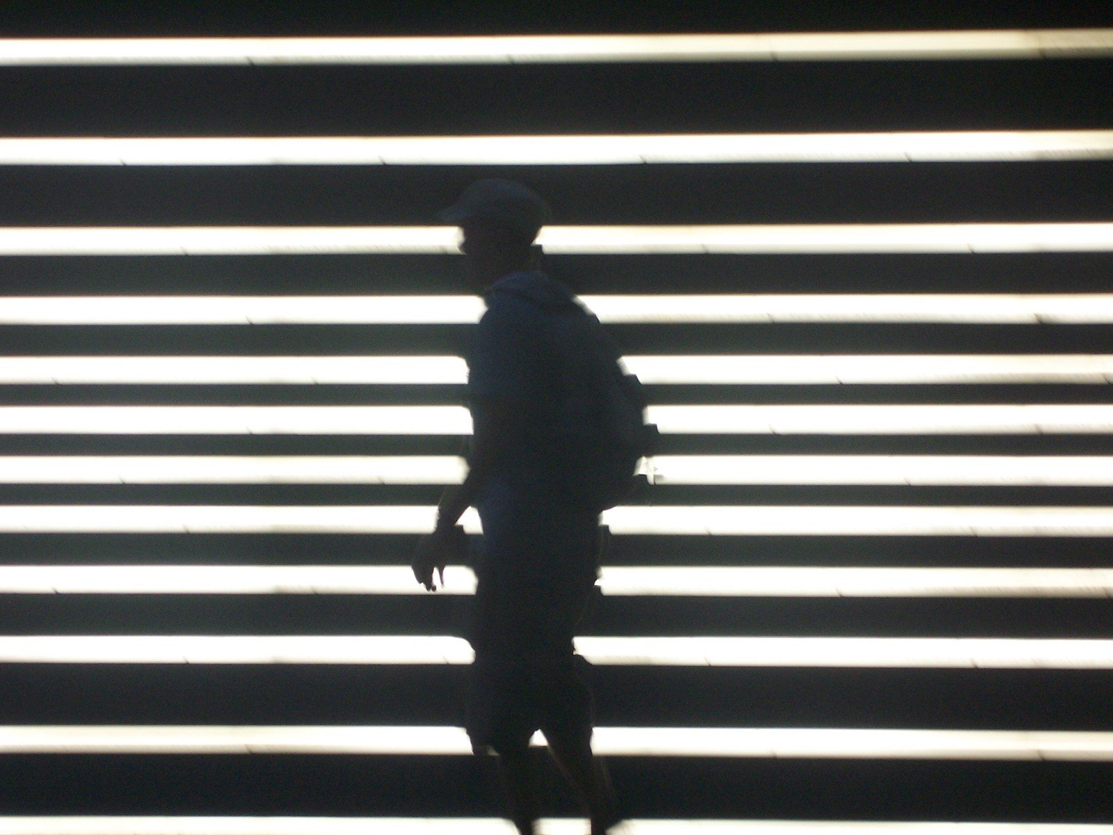a person standing in front of a striped wall
