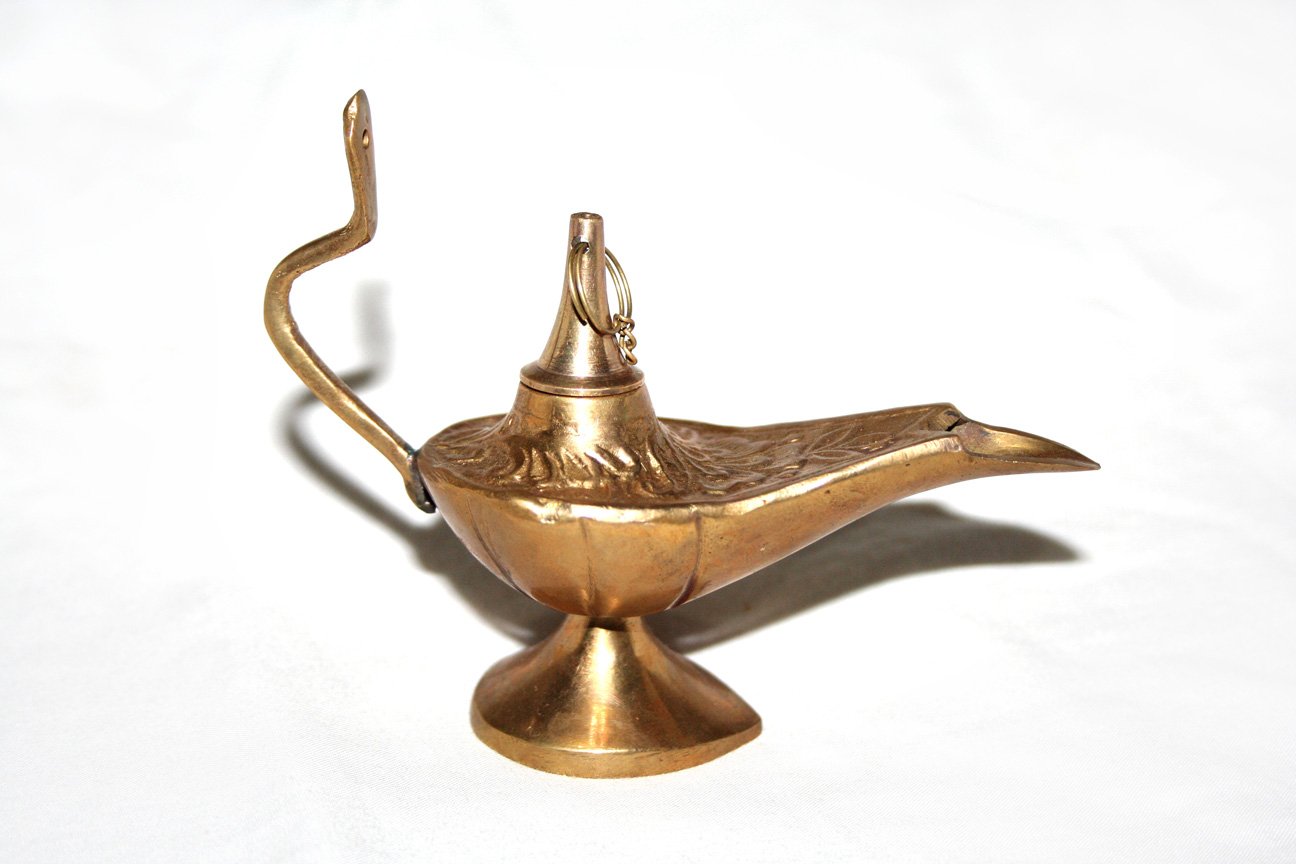 a ss colored tea pot holding a decorative hook