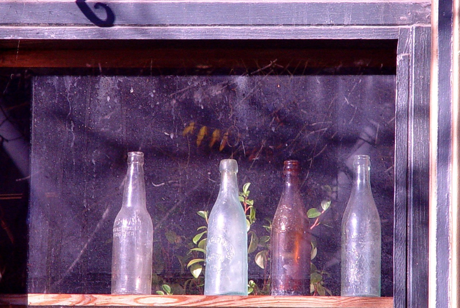 an image of different glass bottles on the shelf