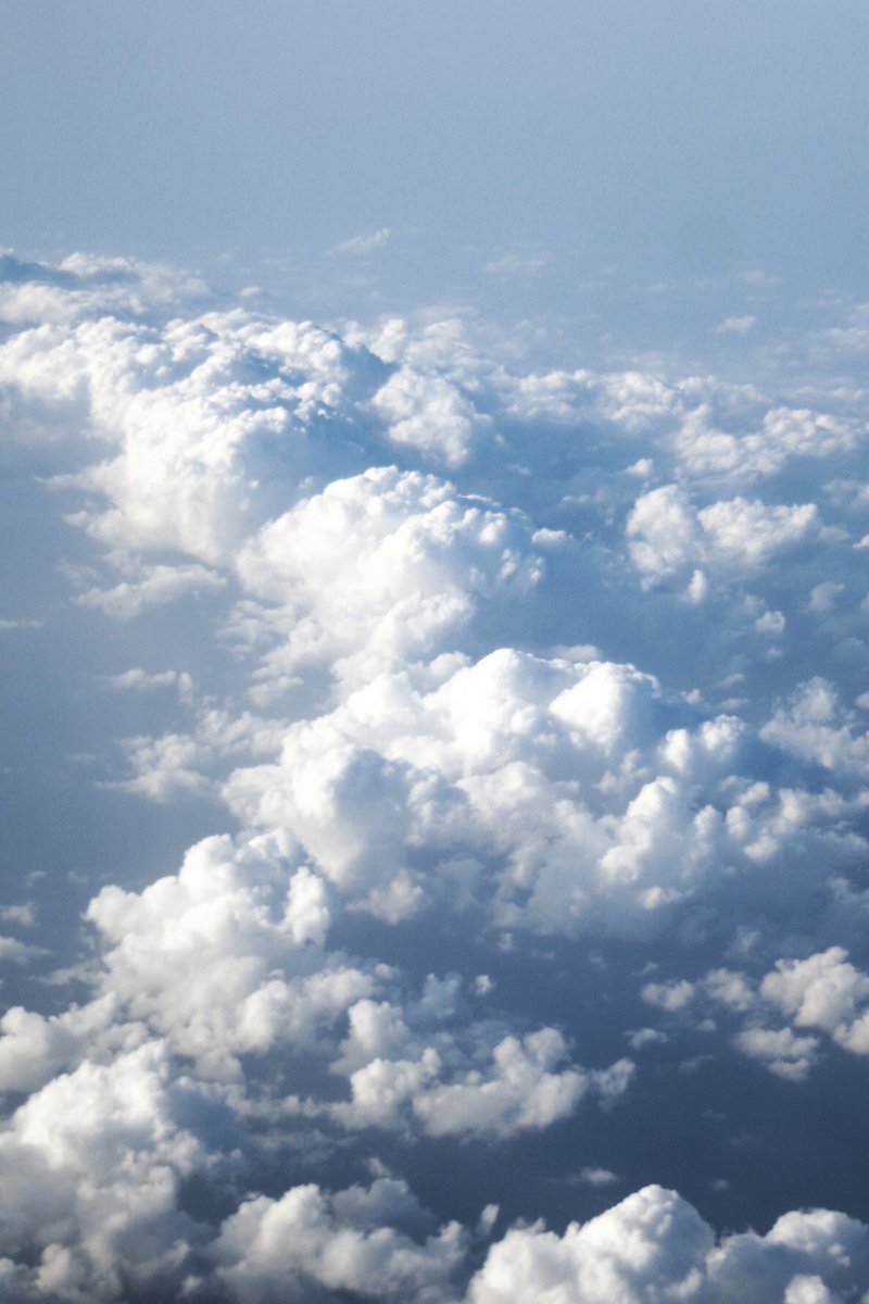 white clouds in the sky are visible from a plane