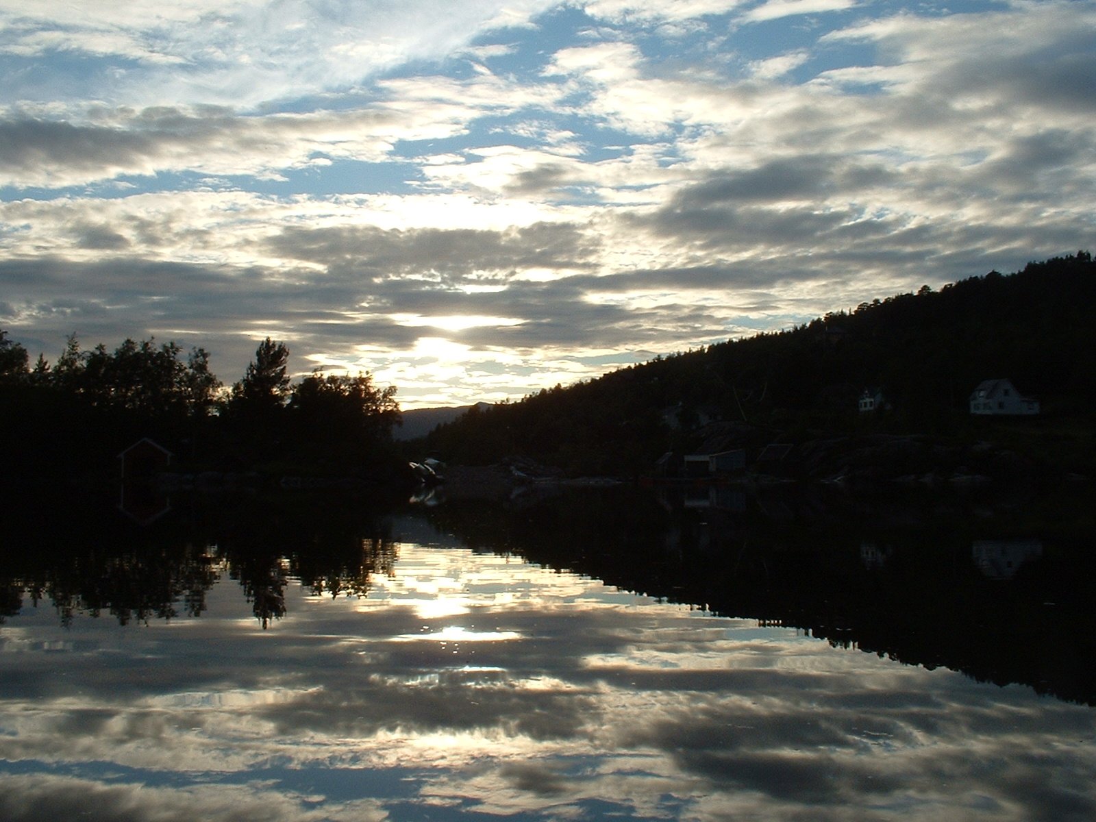 a beautiful cloudy sky at sunset reflecting off a body of water