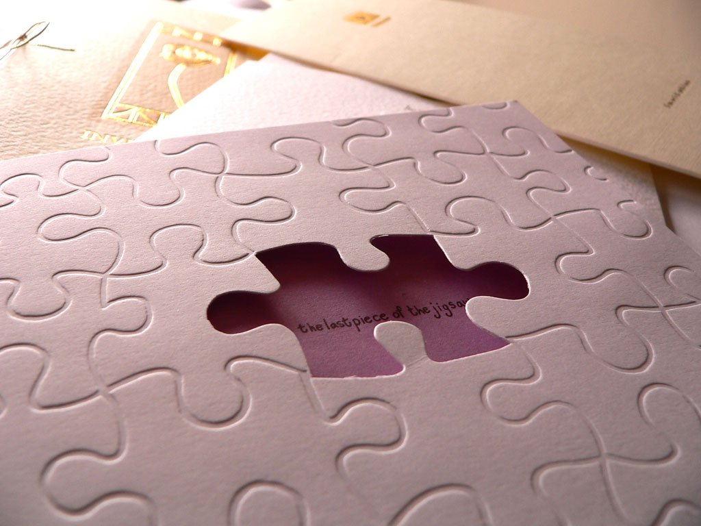 a piece of jigsaw puzzle sitting on top of a paper