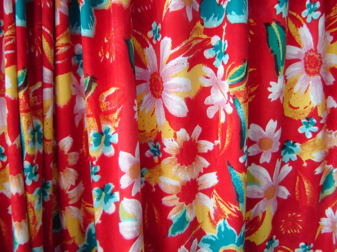 red floral curtains hanging on a rod door