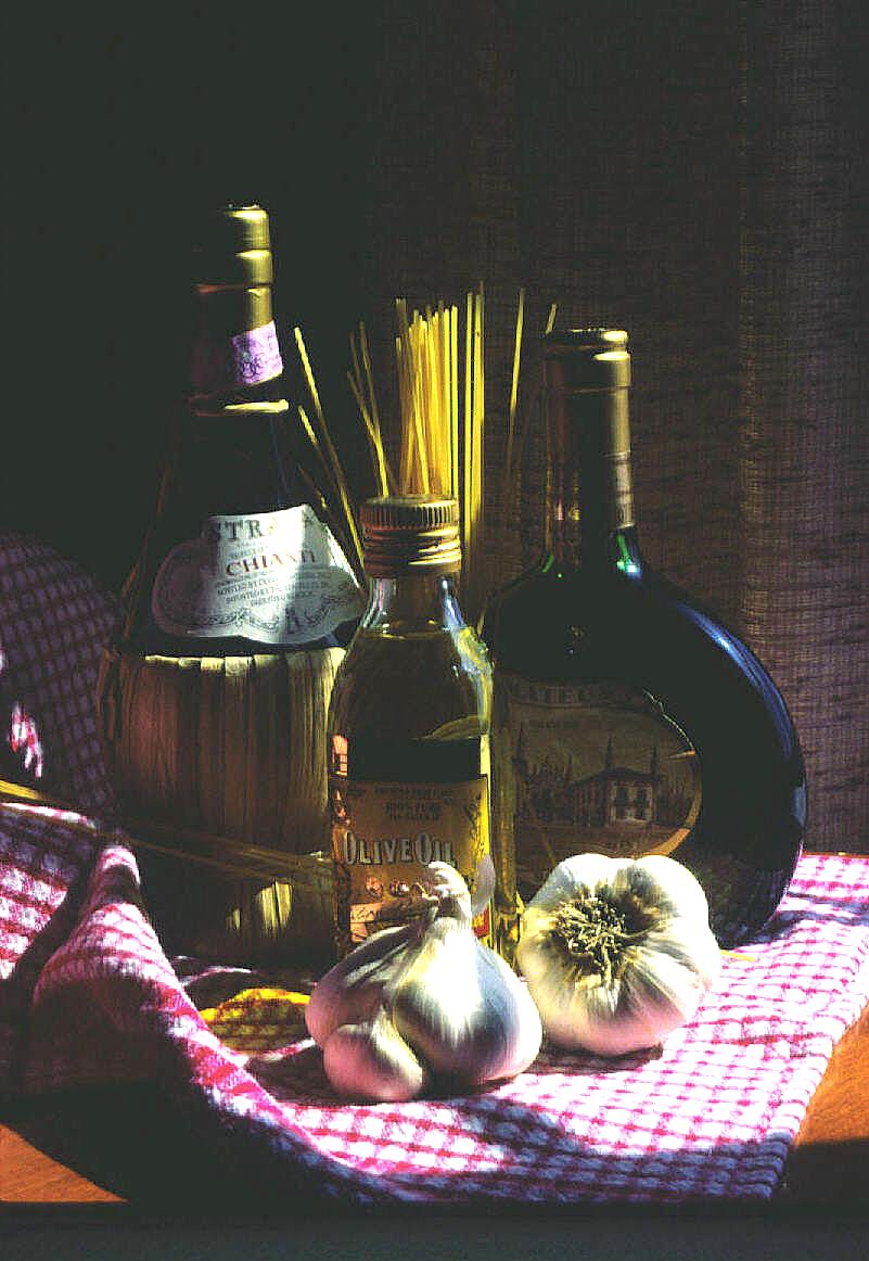 an assortment of items such as pasta, garlic, and wine