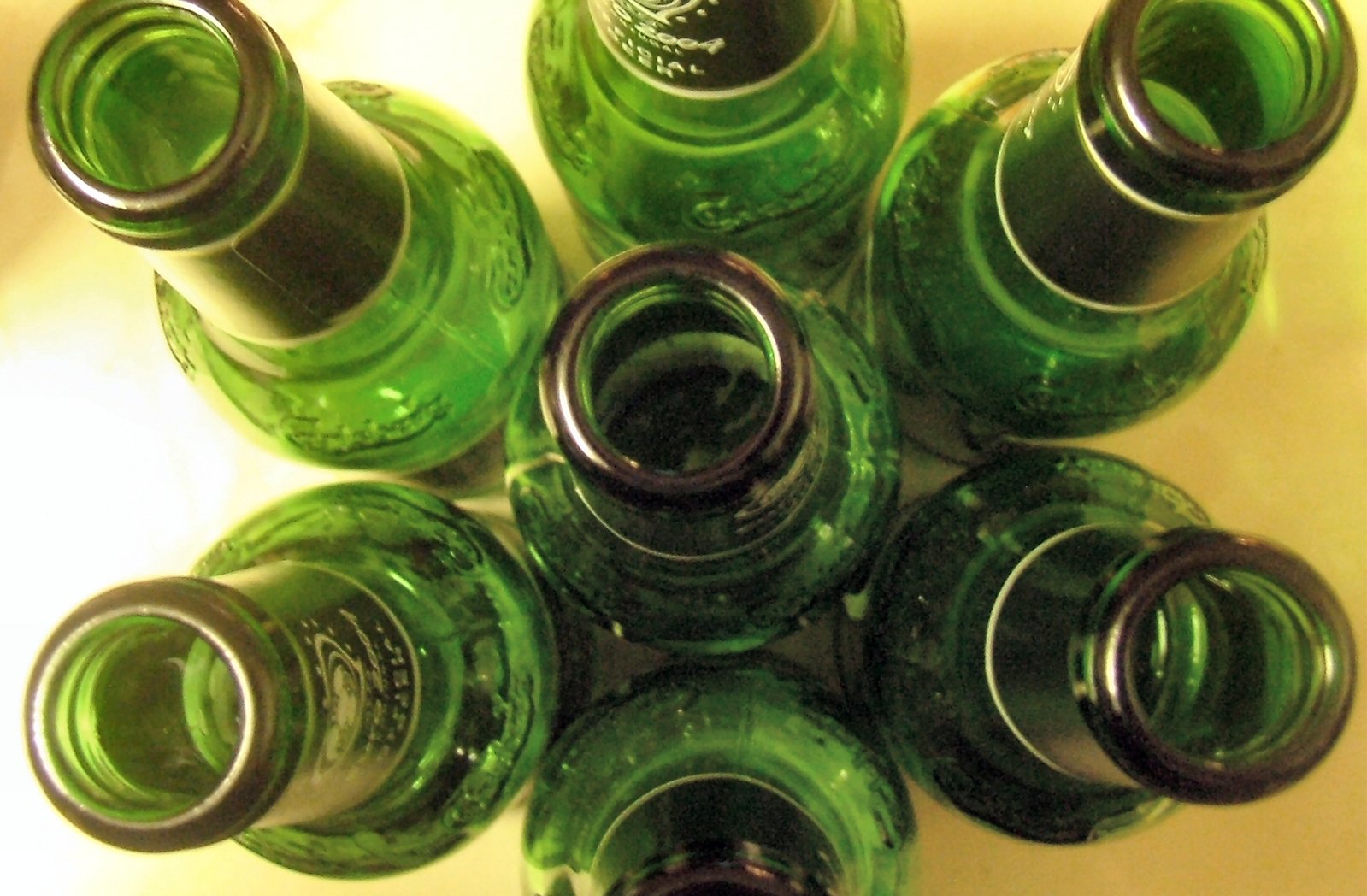 a large bunch of green bottles stacked together