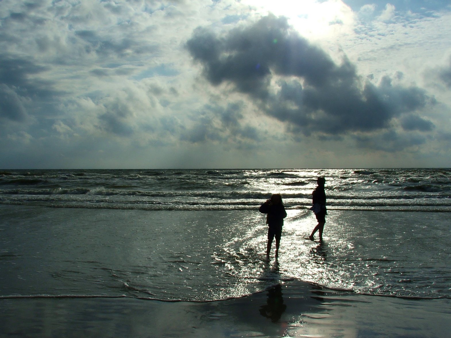 two people on a beach holding hands