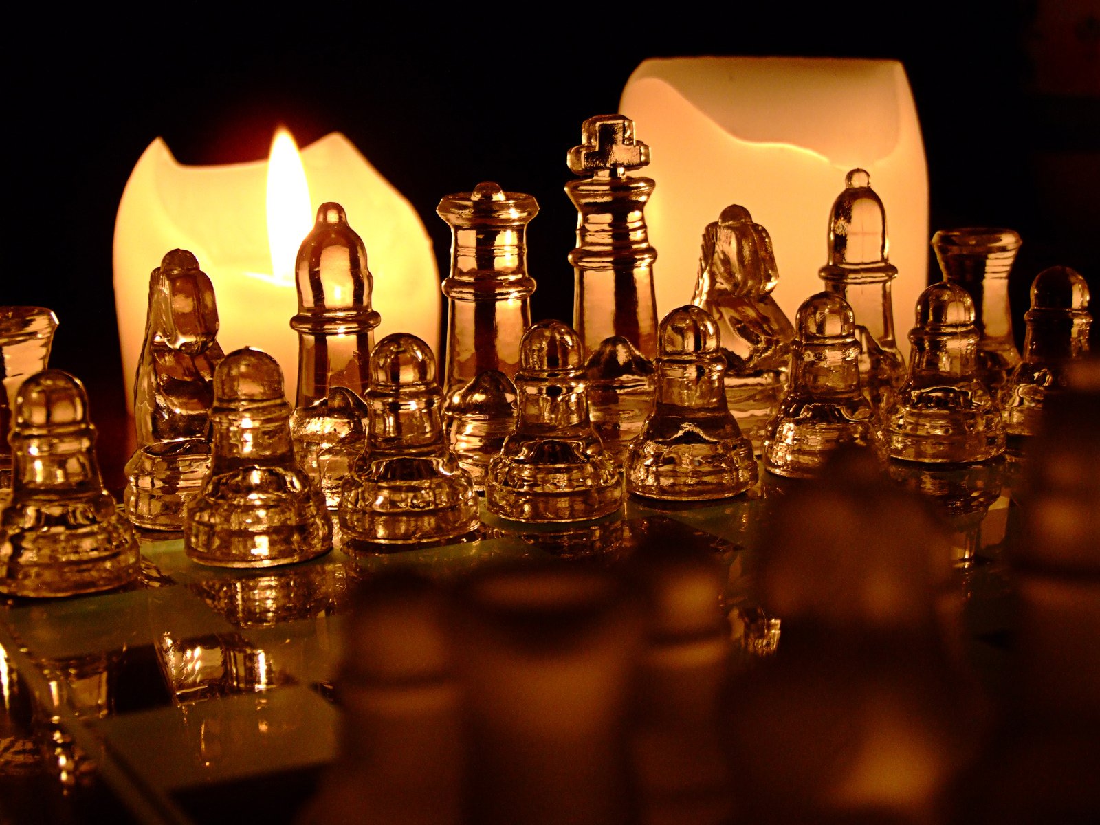 a large collection of candles with clear glass on the mantle